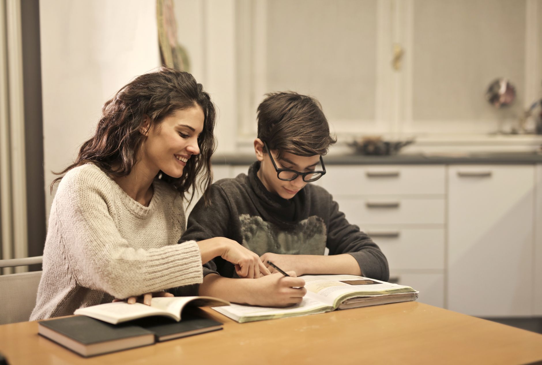 A tutor and student working together at home